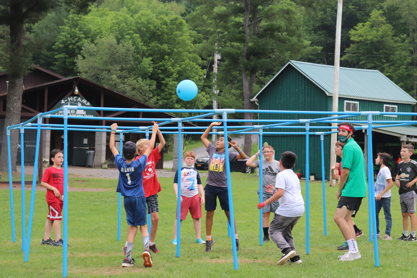 youth participating in game of 9 square alongside a counselor