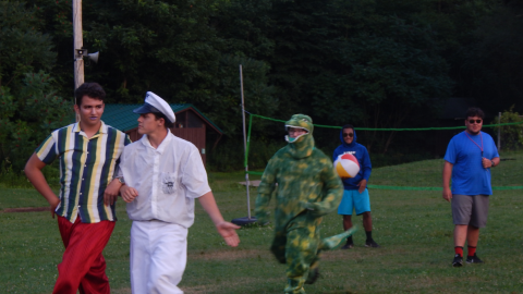 campers dressed in various costumes strolling around the counselor.