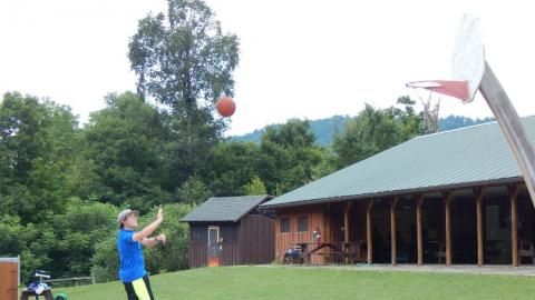 Youth shooting a basket on the b-ball court.