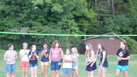Cabin group standing in line in front of rest of camp.