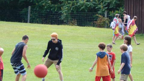 Youth outdoors playing with a ball.