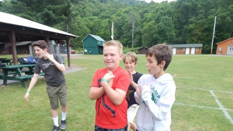 Youth participate in trust falls with a partner.