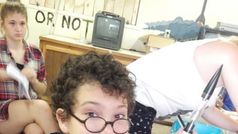 Camper holding up the model rocket they are working on.