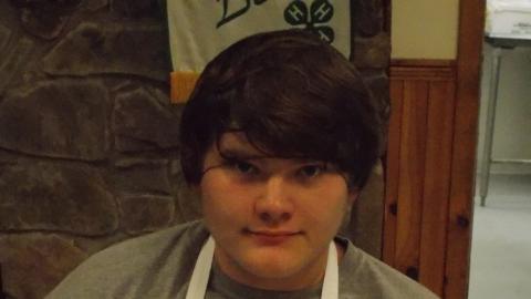 camper holding culinary creation 