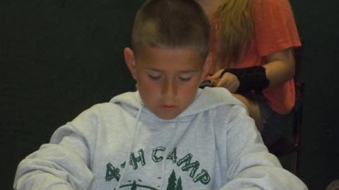 camper creates crafts out of marshmallows and toothpicks