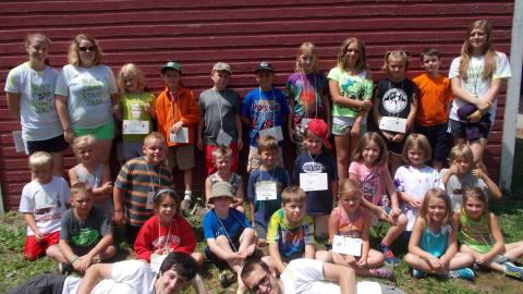 camp counselors pose with day campers 