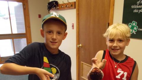 two campers holding fish they caught