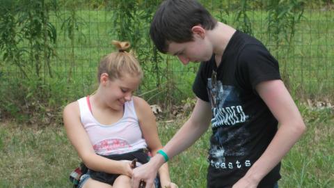 campers cooking outdoors using coffee cans
