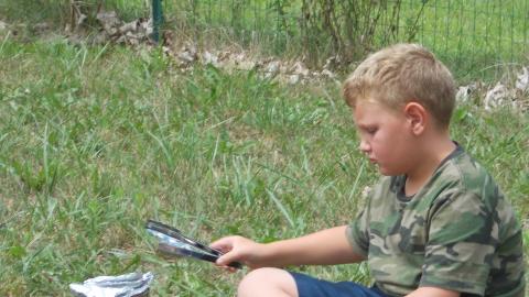 camper cooking outdoors using coffee can 