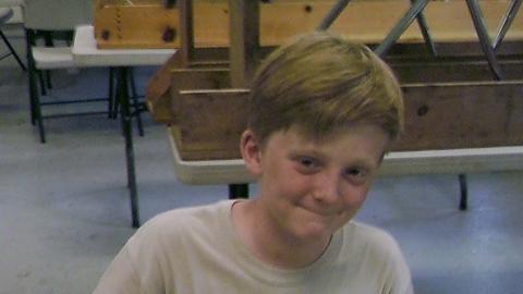 camper making chain mail craft