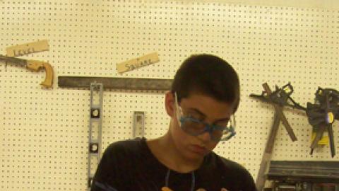 camper using a level while constructing his woodworking project.