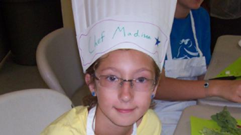 Chef Madison displays a baked potato mouse she crafted from veggies.