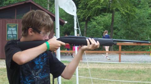 Youth taking aim with air rifle.