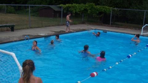 campers swimming in the pool.