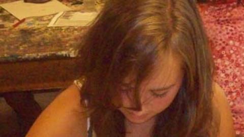 teen youth painting a rock to resemble duck/chicken