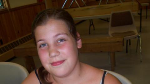 youth showing off a pizza they made.