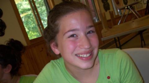 camper displaying a pizza they made.