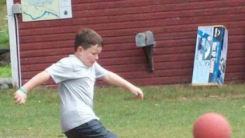 youth kicking a ball