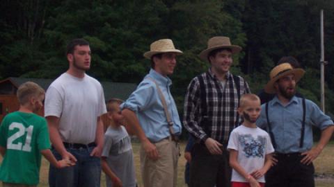 group of campers and staff with overalls and real or pretend beards.