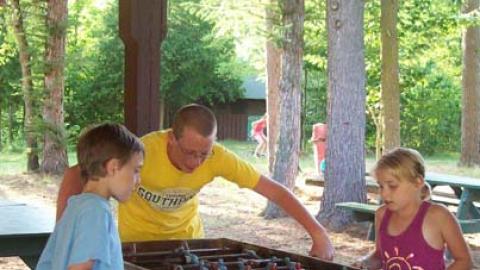 Youth play a friendly game of Foosball. 