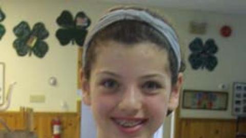 Youth displaying culinary creation.