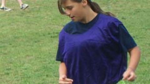 Youth dribbling a soccer ball.
