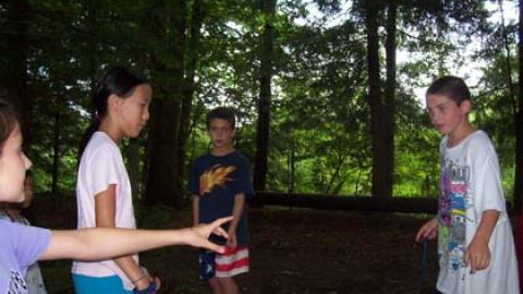 Youth balancing on wooden platform.