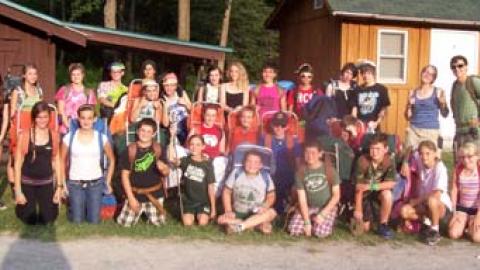 Youth stand for a photo before beginning to backpack. 