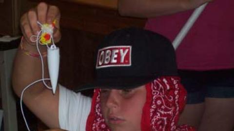 Youth works on a model rocket. 