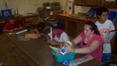 Youth work on model rockets during a rocketry class. 