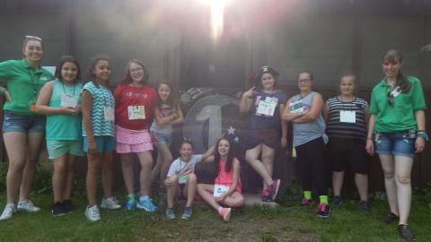 A cabin of youth pose for a photo with their counselors. 