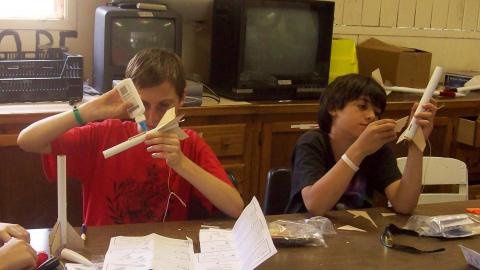 Campers creating model rockets. 
