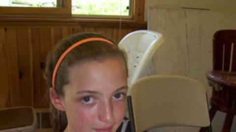 youth displaying a pizza they made.