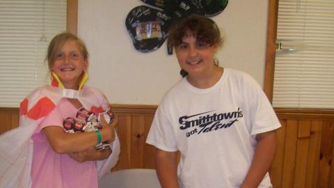 Campers set table in the dining hall. 