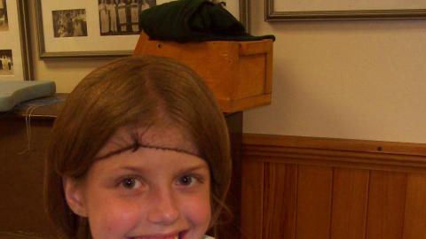 Youth smiles while preparing ground beef as a part of the cooking program. 
