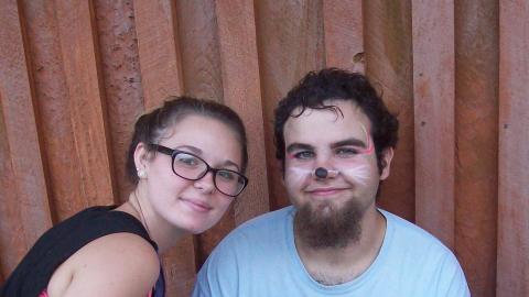Youth smiling while face painting.