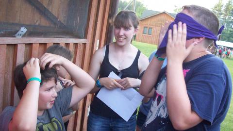 Youth play a silly game with a blindfold. 
