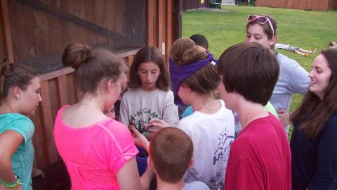 Campers play a game with one player blind folded. 
