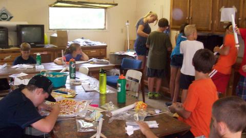 Youth work on model rockets. 