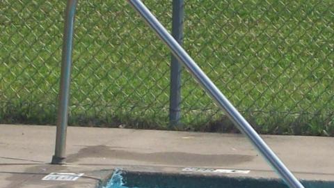 Youth swimming in the camp pool. 
