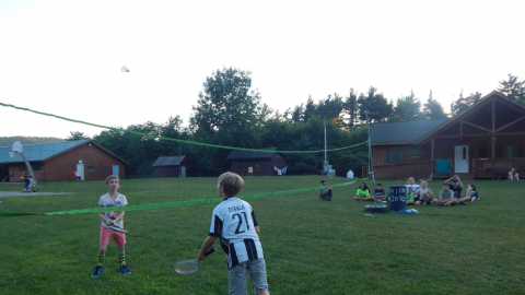Two youth playing badminton.