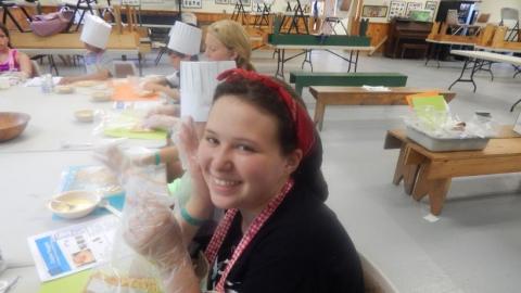 Camper participating in the chef's club shows food. 
