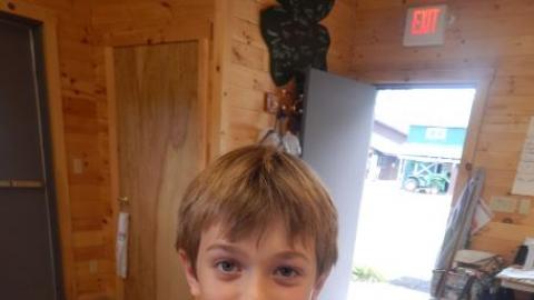 Youth shows off a craft project. 