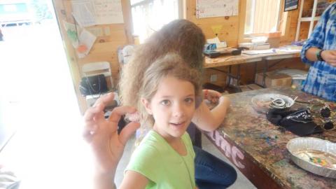 camper showing a bead to the photographer 