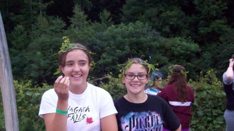 two campers with crowns made out of foliage on their heads 