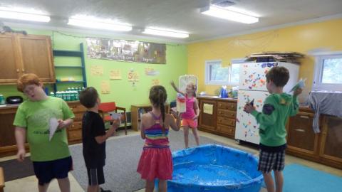 day campers flying paper airplanes 