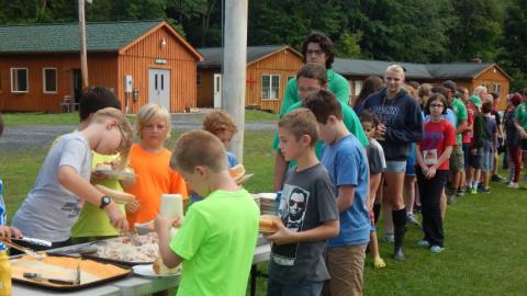 Youth standing in line for food. 