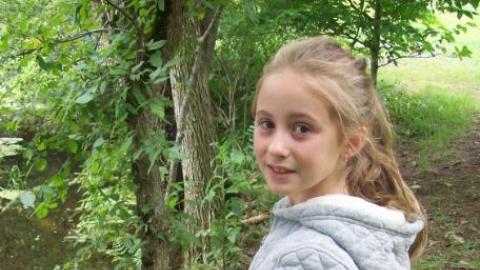 Camper smiling while fishing. 