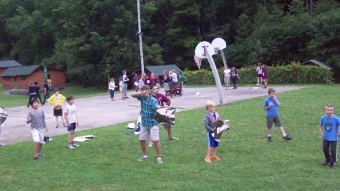 Youth participating in a pretend jousting competition. 