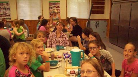 Campers eat a meal in the dining hall. 